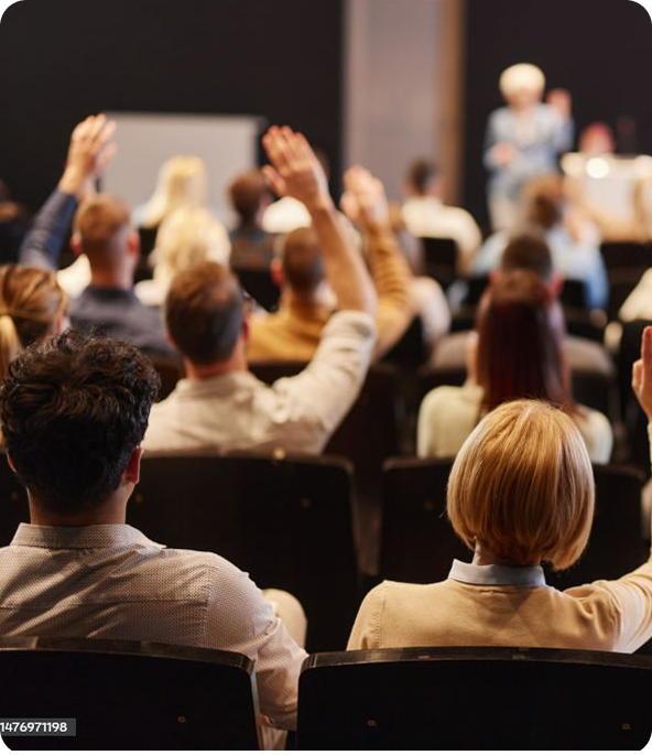 Hands raised at symposium